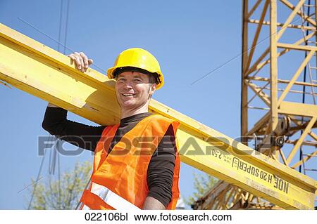 portrait of construction worker carrying wooden plank View Large Photo Image Stock Image - portrait of construction worker carrying wooden plank. Fotosearch