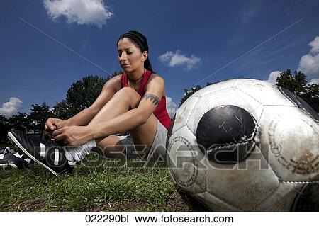 portrait of female football player tying her shoes View Large Photo Image Stock Image - portrait of female football player tying her shoes. Fotosearch