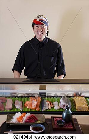 portrait of japanese chef presenting sushi in restaurant View Large Photo Image Stock Image - portrait of japanese chef presenting sushi in restaurant. Fotosearch