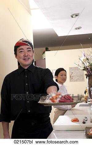 portrait of japanese chef presenting plate with sushi View Large Photo Image Stock Image - portrait of japanese chef presenting plate with sushi. Fotosearch