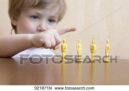 portrait of little boy playing with toy soldiers View Large Photo Image Stock Image - portrait of little boy playing with toy soldiers. Fotosearch