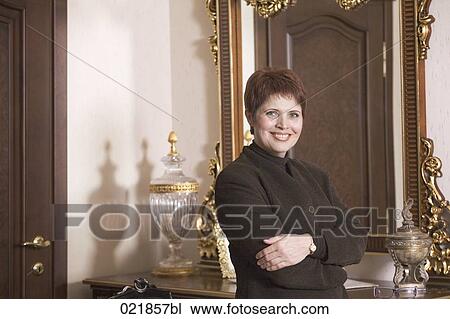portrait of mature woman in front of mirror View Large Photo Image Stock Image - portrait of mature woman in front of mirror. Fotosearch
