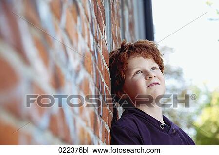 portrait of red haired boy leaning against wall View Large Photo Image Stock Image - portrait of red haired boy leaning against wall. Fotosearch