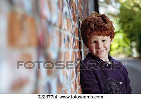 portrait of red haired boy leaning against wall View Large Photo Image Stock Image - portrait of red haired boy leaning against wall. Fotosearch