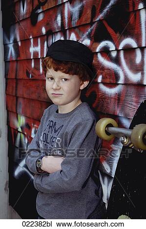 portrait of red haired boy with skateboard leaning against wall View Large Photo Image Stock Image - portrait of red haired boy with skateboard leaning against wall. Fotosearch