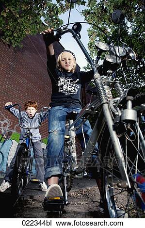 portrait of two young boys on chopper bicycles View Large Photo Image Stock Image - portrait of two young boys on chopper bicycles. Fotosearch