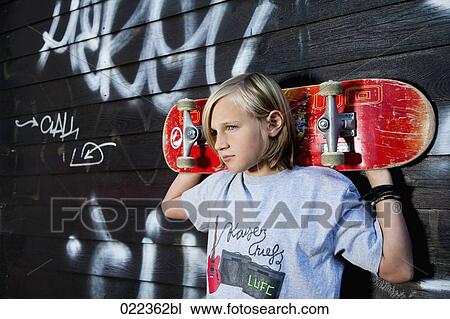 portrait of young boy with skateboard View Large Photo Image Stock Image - portrait of young boy with skateboard. Fotosearch