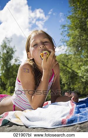 portrait of young girl in summer eating apple View Large Photo Image Stock Image - portrait of young girl in summer eating apple. Fotosearch