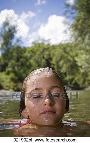 portrait of young girl swimming in water with eyes closed View Large Photo Image Stock Image - portrait of young girl swimming in water with eyes closed. Fotosearch