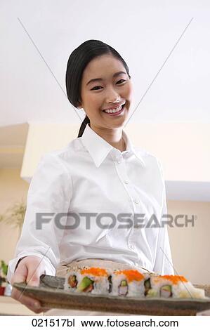 portrait of young japanese waitress serving sushi View Large Photo Image Stock Image - portrait of young japanese waitress serving sushi. Fotosearch