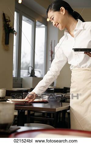 portrait of young japanese waitress setting table at restaurant View Large Photo Image Stock Image - portrait of young japanese waitress setting table at restaurant. Fotosearch