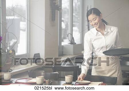 portrait of young japanese waitress setting table at restaurant View Large Photo Image Stock Image - portrait of young japanese waitress setting table at restaurant. Fotosearch