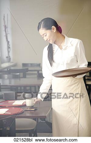 portrait of young japanese waitress setting table at restaurant View Large Photo Image Stock Image - portrait of young japanese waitress setting table at restaurant. Fotosearch