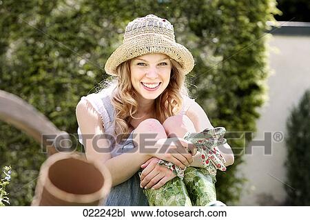 portrait of young woman in garden wearing straw hat View Large Photo Image Stock Image - portrait of young woman in garden wearing straw hat. Fotosearch
