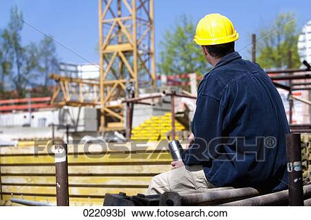 rear view of construction worker taking a break View Large Photo Image Stock Image - rear view of construction worker taking a break. Fotosearch