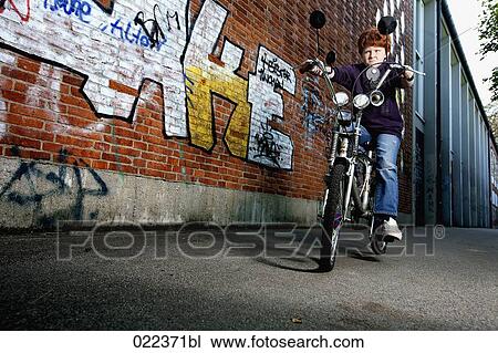 Stock Image - red haired boy on chopper bicycle. Fotosearch