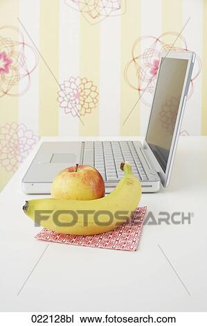 still life of apple and banana with laptop on table View Large Photo Image Stock Image - still life of apple and banana with laptop on table . Fotosearch