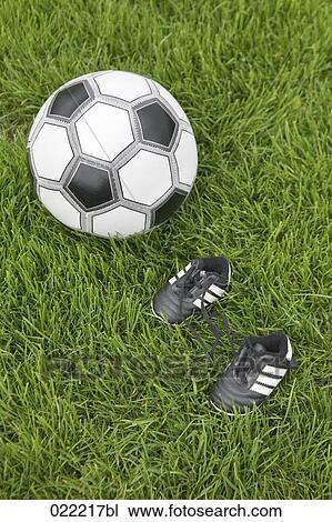 still life of ball and tiny football boots View Large Photo Image Stock Image - still life of ball and tiny football boots. Fotosearch