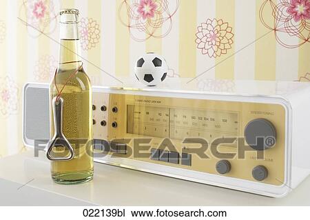 still life of beer bottle radio and football View Large Photo Image Stock Image - still life of beer bottle radio and football. Fotosearch