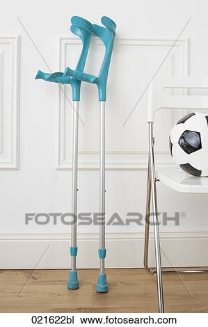 still life of crutches and football on chair View Large Photo Image Stock Image - still life of crutches and football on chair. Fotosearch