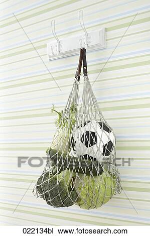 still life of vegetables and football in string bag on coat hook View Large Photo Image Stock Image - still life of vegetables and football in string bag on coat hook. Fotosearch