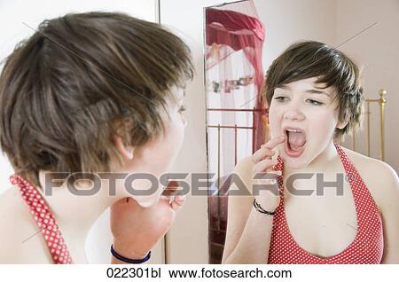 teenage girl checking her make-up in mirror View Large Photo Image Stock Image - teenage girl checking her make-up in mirror. Fotosearch