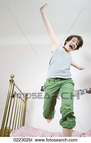 teenage girl jumping on bed View Large Photo Image Stock Image - teenage girl jumping on bed. Fotosearch