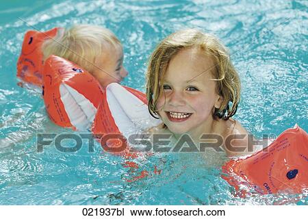 two little children wearing water wings swimming in pool View Large Photo Image Stock Image - two little children wearing water wings swimming in pool. Fotosearch