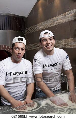 Stock Image - two pizza bakers making dough. Fotosearch