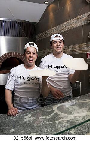 Stock Image - two pizza bakers making dough. Fotosearch