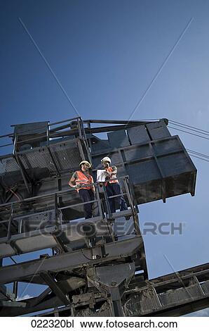 two workers having conversation on excavator View Large Photo Image Stock Image - two workers having conversation on excavator. Fotosearch
