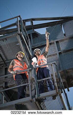 two workers having conversation on excavator View Large Photo Image Stock Image - two workers having conversation on excavator. Fotosearch