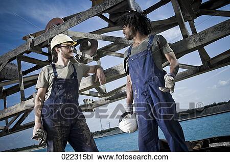 two workers having conversation View Large Photo Image Stock Image - two workers having conversation. Fotosearch