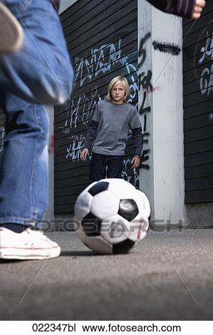 two young boys playing street football View Large Photo Image Stock Image - two young boys playing street football. Fotosearch