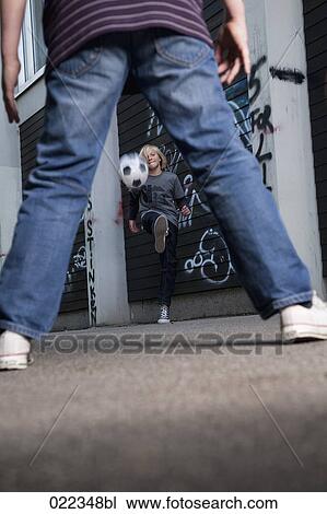 two young boys playing street football View Large Photo Image Stock Image - two young boys playing street football. Fotosearch