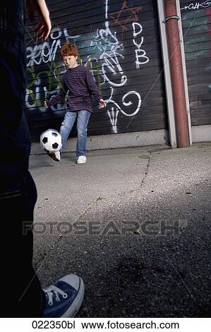 two young boys playing street football View Large Photo Image Stock Image - two young boys playing street football. Fotosearch