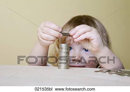 young boy making pile of coins View Large Photo Image Stock Image - young boy making pile of coins. Fotosearch