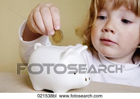 young boy putting money into piggybank View Large Photo Image Stock Image - young boy putting money into piggybank. Fotosearch