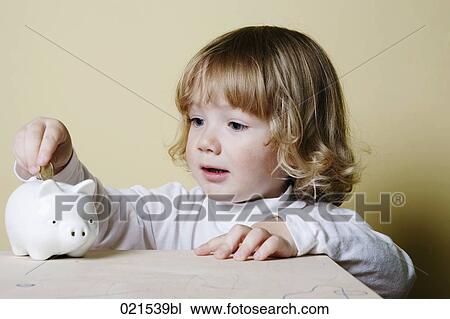 young boy putting money into piggybank View Large Photo Image Stock Image - young boy putting money into piggybank. Fotosearch