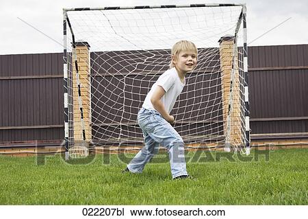 young boy standing in football goal View Large Photo Image Stock Image - young boy standing in football goal. Fotosearch