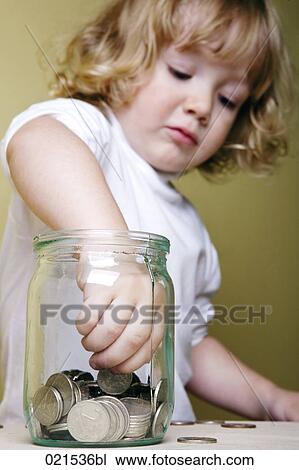 young boy taking money out of jar View Large Photo Image Stock Image - young boy taking money out of jar. Fotosearch