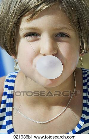 Stock Image - young girl blowing bubblegum. Fotosearch