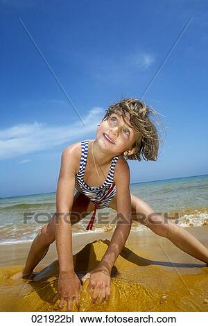 young girl on beach playing with sand View Large Photo Image Stock Image - young girl on beach playing with sand. Fotosearch