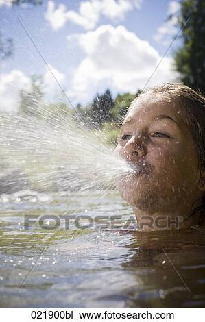 young girl spitting water while swimming View Large Photo Image Stock Image - young girl spitting water while swimming. Fotosearch