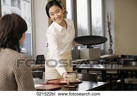 young japanese waitress serving guest at restaurant View Large Photo Image Stock Image - young japanese waitress serving guest at restaurant. Fotosearch