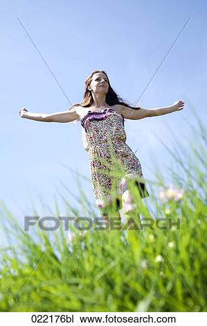 young woman running through grass in park View Large Photo Image Stock Image - young woman running through grass in park. Fotosearch