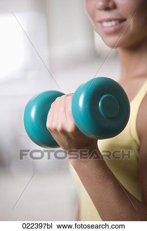 close-up of young woman exercising with dumb bell View Large Photo Image Stock Image - close-up of young woman exercising with dumb bell. Fotosearch