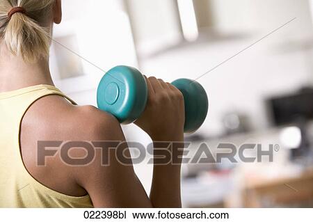 close-up of young woman exercising with dumb bell View Large Photo Image Stock Image - close-up of young woman exercising with dumb bell. Fotosearch