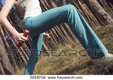 detail of woman doing stretching exercises in forest View Large Photo Image Stock Image - detail of woman doing stretching exercises in forest. Fotosearch