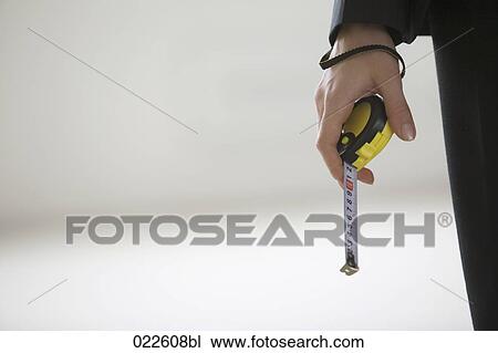 detail of young woman holding tape measure View Large Photo Image Stock Image - detail of young woman holding tape measure. Fotosearch